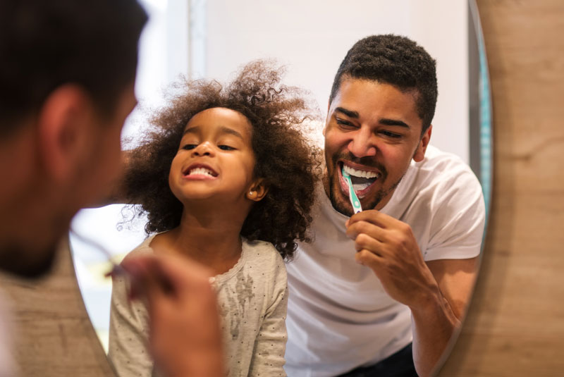 father and daughter brushing teeth Pittsfield, MA